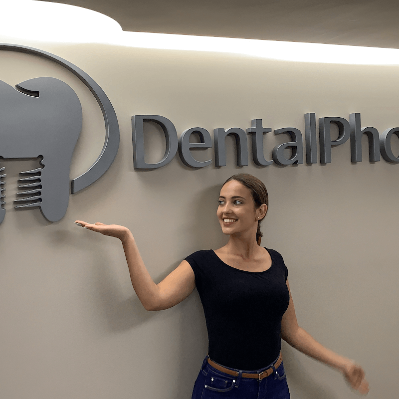 Picture of DentalPhoto logo on a wall with a girl